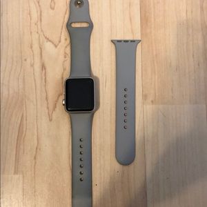 Series 1 gold Apple Watch with gray band